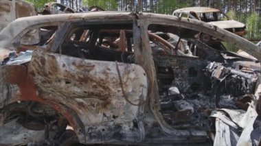 This stock video shows a dump of shot and burned cars in Irpin, Bucha district in 8K resolution