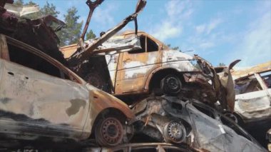 This stock video shows a dump of shot and burned cars in Irpin, Bucha district in 8K resolution