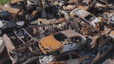 This stock video shows a dump of shot and burned cars in Irpin, Bucha district in 8K resolution