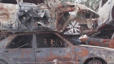 This stock video shows a dump of shot and burned cars in Irpin, Bucha district in 8K resolution