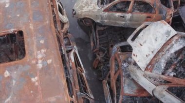 This stock video shows a dump of shot and burned cars in Irpin, Bucha district in 8K resolution
