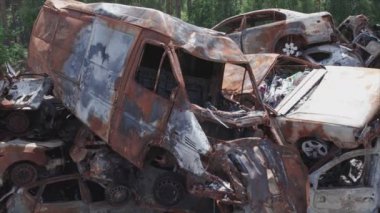 This stock video shows a dump of shot and burned cars in Irpin, Bucha district in 8K resolution