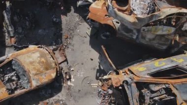 This stock video shows a dump of shot and burned cars in Irpin, Bucha district in 8K resolution