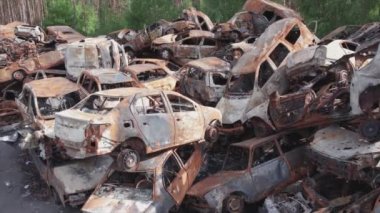 This stock video shows a dump of shot and burned cars in Irpin, Bucha district in 8K resolution