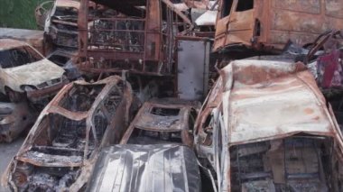 This stock video shows a dump of shot and burned cars in Irpin, Bucha district in 8K resolution
