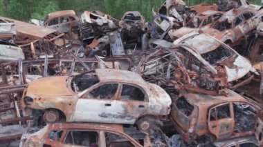 This stock video shows a dump of shot and burned cars in Irpin, Bucha district in 8K resolution