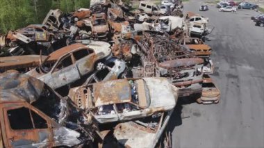This stock video shows a dump of shot and burned cars in Irpin, Bucha district in 8K resolution