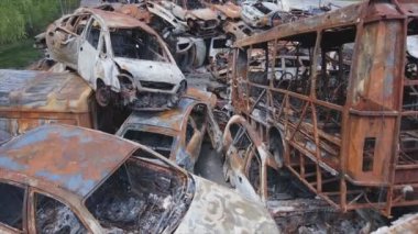 This stock video shows a dump of shot and burned cars in Irpin, Bucha district in 8K resolution