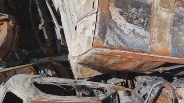 This stock video shows a dump of shot and burned cars in Irpin, Bucha district in 8K resolution