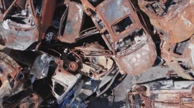 This stock video shows a dump of shot and burned cars in Irpin, Bucha district in 8K resolution