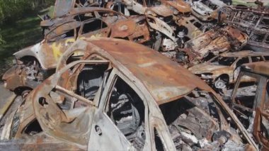 This stock video shows a dump of shot and burned cars in Irpin, Bucha district in 8K resolution