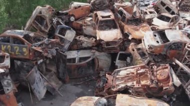 This stock video shows a dump of shot and burned cars in Irpin, Bucha district in 8K resolution