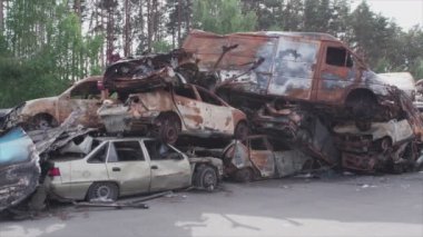 This stock video shows a dump of shot and burned cars in Irpin, Bucha district in 8K resolution