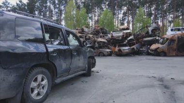 This stock video shows a dump of shot and burned cars in Irpin, Bucha district in 8K resolution