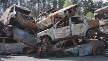 This stock video shows a dump of shot and burned cars in Irpin, Bucha district in 8K resolution