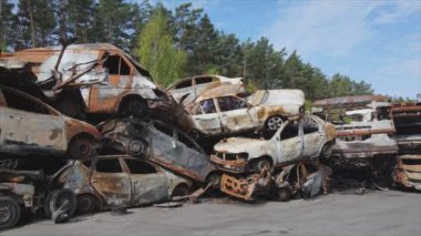 This stock video shows a dump of shot and burned cars in Irpin, Bucha district in 8K resolution