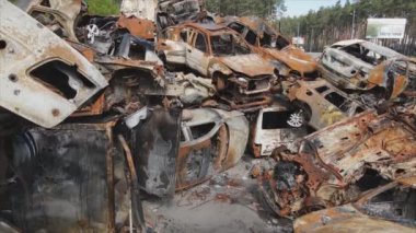 This stock video shows a dump of shot and burned cars in Irpin, Bucha district in 8K resolution
