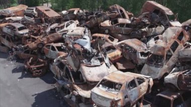 This stock video shows a dump of shot and burned cars in Irpin, Bucha district in 8K resolution