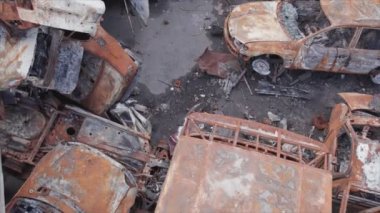 This stock video shows a dump of shot and burned cars in Irpin, Bucha district in 8K resolution