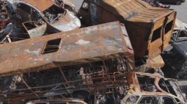 This stock video shows a dump of shot and burned cars in Irpin, Bucha district in 8K resolution