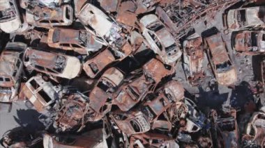 This stock video shows a dump of shot and burned cars in Irpin, Bucha district in 8K resolution