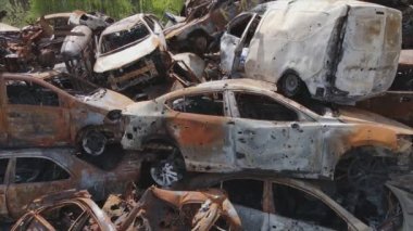 This stock video shows a dump of shot and burned cars in Irpin, Bucha district in 8K resolution