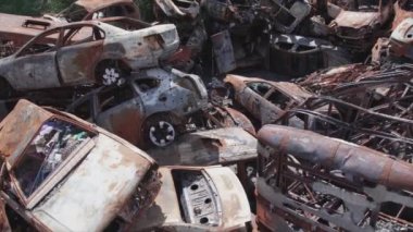This stock video shows a dump of shot and burned cars in Irpin, Bucha district in 8K resolution