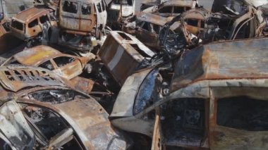 This stock video shows a dump of shot and burned cars in Irpin, Bucha district in 8K resolution