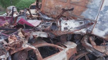 This stock video shows a dump of shot and burned cars in Irpin, Bucha district in 8K resolution
