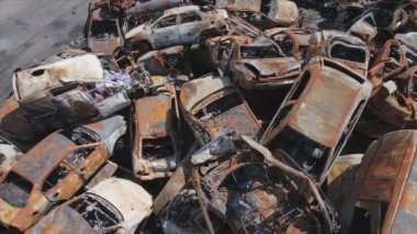 This stock video shows a dump of shot and burned cars in Irpin, Bucha district in 8K resolution