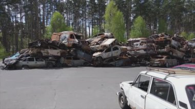 This stock video shows a dump of shot and burned cars in Irpin, Bucha district in 8K resolution