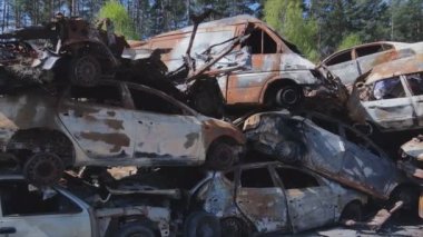 This stock video shows a dump of shot and burned cars in Irpin, Bucha district in 8K resolution