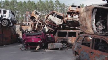 This stock video shows a dump of shot and burned cars in Irpin, Bucha district in 8K resolution