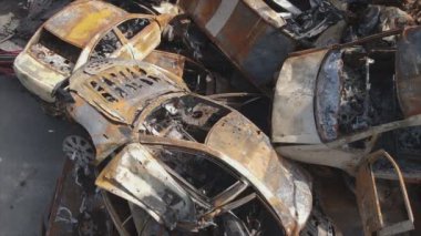This stock video shows a dump of shot and burned cars in Irpin, Bucha district in 8K resolution