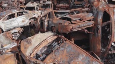 This stock video shows a dump of shot and burned cars in Irpin, Bucha district in 8K resolution
