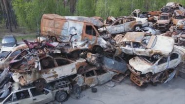 This stock video shows a dump of shot and burned cars in Irpin, Bucha district in 8K resolution