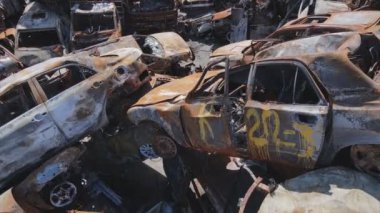 This stock video shows a dump of shot and burned cars in Irpin, Bucha district in 8K resolution