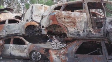 This stock video shows a dump of shot and burned cars in Irpin, Bucha district in 8K resolution