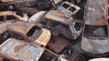 This stock video shows a dump of shot and burned cars in Irpin, Bucha district in 8K resolution