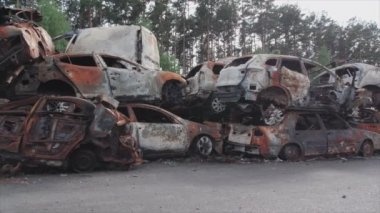 This stock video shows a dump of shot and burned cars in Irpin, Bucha district in 8K resolution