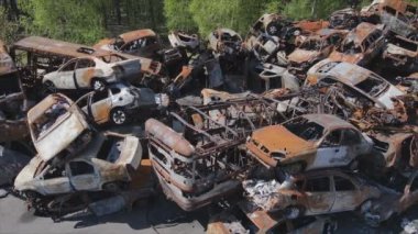 This stock video shows a dump of shot and burned cars in Irpin, Bucha district in 8K resolution