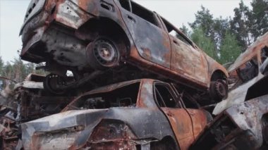 This stock video shows a dump of shot and burned cars in Irpin, Bucha district in 8K resolution