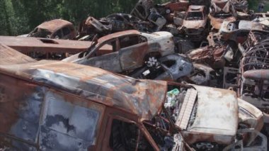 This stock video shows a dump of shot and burned cars in Irpin, Bucha district in 8K resolution