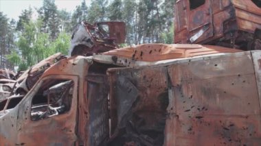 This stock video shows a dump of shot and burned cars in Irpin, Bucha district in 8K resolution