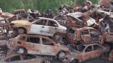 This stock video shows a dump of shot and burned cars in Irpin, Bucha district in 8K resolution