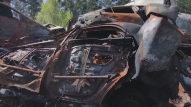 This stock video shows a dump of shot and burned cars in Irpin, Bucha district in 8K resolution