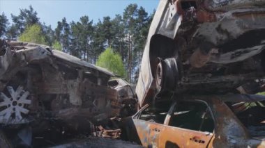 This stock video shows a dump of shot and burned cars in Irpin, Bucha district in 8K resolution