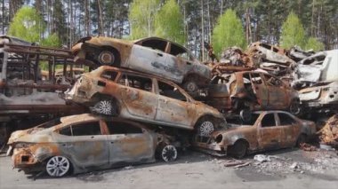 This stock video shows a dump of shot and burned cars in Irpin, Bucha district in 8K resolution