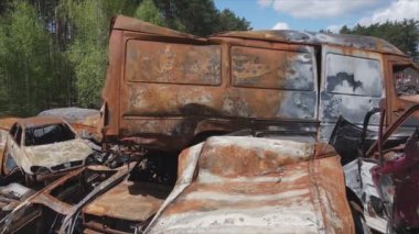 This stock video shows a dump of shot and burned cars in Irpin, Bucha district in 8K resolution
