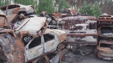 This stock video shows a dump of shot and burned cars in Irpin, Bucha district in 8K resolution